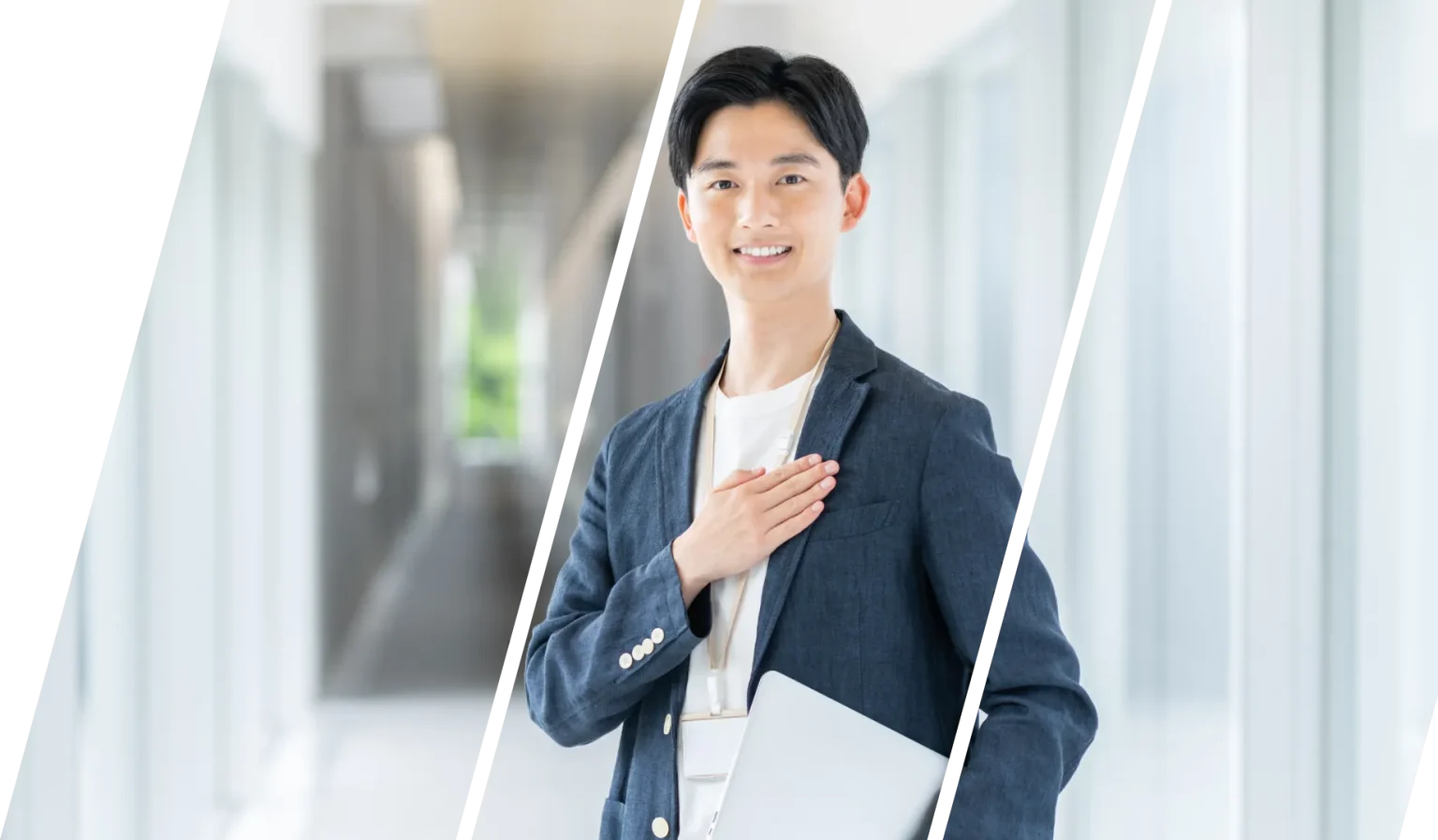明るい廊下でノートパソコンを持ち胸に手を当てる人物